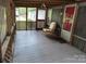 Spacious covered porch with outdoor seating, ideal for enjoying a quiet afternoon at 189 6Th Ave, New London, NC 28127