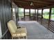 A spacious covered porch with a sitting area, perfect for relaxation and enjoying the outdoors at 189 6Th Ave, New London, NC 28127