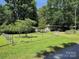 Large grassy yard enclosed by a chain-link fence, providing a safe and spacious area at 189 6Th Ave, New London, NC 28127