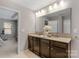 Bathroom featuring double sinks, granite countertops, and a large mirror at 1919 Madeira Cir, Waxhaw, NC 28173
