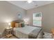 Cozy bedroom with natural light, neutral walls, and a comfortable queen-sized bed at 1919 Madeira Cir, Waxhaw, NC 28173