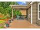 Covered deck features a ceiling fan and a cozy outdoor dining area at 1919 Madeira Cir, Waxhaw, NC 28173