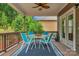 Covered deck featuring a dining set, ceiling fan, and views of the surrounding greenery at 1919 Madeira Cir, Waxhaw, NC 28173