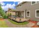 Back deck features outdoor seating area, potted plants, and brick walkway at 1919 Madeira Cir, Waxhaw, NC 28173