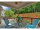 Outdoor deck offers scenic views with a table, chairs and colorful landscaping at 1919 Madeira Cir, Waxhaw, NC 28173
