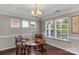Bright dining area featuring hardwood floors, natural light, and elegant chair rail molding details at 1919 Madeira Cir, Waxhaw, NC 28173