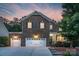 Charming brick home boasts a three-car garage, classic shutters, and a welcoming front porch at 1919 Madeira Cir, Waxhaw, NC 28173