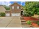 Charming two-story brick home featuring an attached three car garage and manicured landscaping at 1919 Madeira Cir, Waxhaw, NC 28173