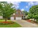 Two-story brick home with a three-car garage, beautiful lawn, and well-manicured landscaping at 1919 Madeira Cir, Waxhaw, NC 28173