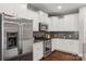 Well-lit kitchen features stainless steel appliances, white cabinets, and sleek design at 1919 Madeira Cir, Waxhaw, NC 28173