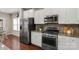 Modern kitchen with stainless steel appliances, granite countertops, and white cabinets at 1919 Madeira Cir, Waxhaw, NC 28173
