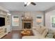 Cozy living room with a stone fireplace, neutral sofa, and natural light at 1919 Madeira Cir, Waxhaw, NC 28173