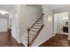 Interior staircase featuring hardwood steps and decorative wrought iron balusters at 1919 Madeira Cir, Waxhaw, NC 28173