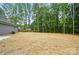 A large backyard with mature trees and a small concrete patio provides a peaceful and private setting at 195 Linda St, Salisbury, NC 28146