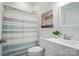 Elegant bathroom featuring a striped shower curtain, a plant, and vanity sink with brushed metal fixtures at 195 Linda St, Salisbury, NC 28146