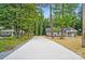 Charming home with a long driveway surrounded by lush greenery and mature trees at 195 Linda St, Salisbury, NC 28146