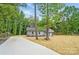 Attractive single-story home with gray exterior and a lengthy driveway surrounded by mature trees at 195 Linda St, Salisbury, NC 28146