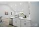 Open-concept kitchen features stainless steel appliances, bright white cabinets and quartz countertops at 195 Linda St, Salisbury, NC 28146