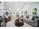 Bright and open living room featuring modern furniture, high ceilings, and a view into the kitchen and dining areas at 195 Linda St, Salisbury, NC 28146