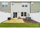 View of the rear of the home showing a patio, privacy fence and small patch of lawn at 2018 Crooked Oak Ln, York, SC 29745