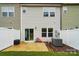Rear of the home showcasing a patio, sliding glass door, privacy fence, and small grassy area at 2018 Crooked Oak Ln, York, SC 29745