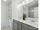 A bathroom features double sinks with a large mirror and neutral-toned cabinets at 2018 Crooked Oak Ln, York, SC 29745