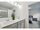 This bathroom has double sinks with a large mirror and neutral-toned cabinets, connected to a bedroom at 2018 Crooked Oak Ln, York, SC 29745