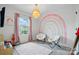 The ' bedroom is decorated with a rainbow mural, white chairs, and colorful toys at 2018 Crooked Oak Ln, York, SC 29745