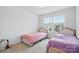 A bright bedroom has two twin beds, neutral walls, and natural light from large windows at 2018 Crooked Oak Ln, York, SC 29745
