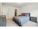 A cozy bedroom features neutral walls, carpet, and a comfortable queen bed with patterned bedding at 2018 Crooked Oak Ln, York, SC 29745