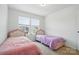 A bright bedroom has two twin beds, neutral walls, and natural light from the windows at 2018 Crooked Oak Ln, York, SC 29745