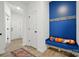 Stylish mud room area with a blue bench, hooks, and a view to the front door at 2018 Crooked Oak Ln, York, SC 29745