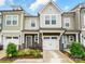 Charming townhome showcasing a stone facade, attached garage and manicured landscaping at 2018 Crooked Oak Ln, York, SC 29745