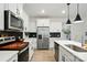 Contemporary kitchen featuring white cabinets, stainless steel appliances, and island sink at 2018 Crooked Oak Ln, York, SC 29745