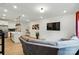 Open-concept living room view showcasing modern decor, TV, and access to the kitchen at 2018 Crooked Oak Ln, York, SC 29745