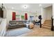 Open-concept living room features a plush gray sectional, wood floors, and natural light at 2018 Crooked Oak Ln, York, SC 29745