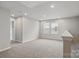 Spacious bonus room with neutral carpeting and ample natural light at 2021 Vinyasa Ln # Sts-41, Charlotte, NC 28215