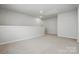 Spacious bonus room offers flexible living space with neutral tones and ample lighting at 2021 Vinyasa Ln # Sts-41, Charlotte, NC 28215