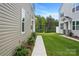 Side view of home with a sidewalk and lush green lawn between two houses at 2021 Vinyasa Ln # Sts-41, Charlotte, NC 28215