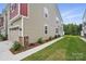 Exterior side view of a two-story home with green grass and a sidewalk at 2021 Vinyasa Ln # Sts-41, Charlotte, NC 28215