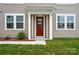 Home featuring a red front door with white trim, and a well-maintained lawn at 2021 Vinyasa Ln # Sts-41, Charlotte, NC 28215