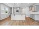 Stylish kitchen with gray cabinets, granite countertops, a kitchen island, and stainless steel appliances at 2021 Vinyasa Ln # Sts-41, Charlotte, NC 28215