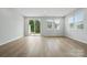 Bright living room boasts wood floors, natural light from windows, and a sliding glass door to outdoors at 2021 Vinyasa Ln # Sts-41, Charlotte, NC 28215