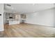 Bright living area with wood floors and a view of the kitchen and stairway at 2021 Vinyasa Ln # Sts-41, Charlotte, NC 28215