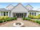 Beautiful backyard with an outdoor seating area, firepit and green landscaping at 2026 Thatcher Way, Fort Mill, SC 29715