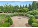 Serene backyard with a gravel fire pit and mature trees and shrubbery at 2026 Thatcher Way, Fort Mill, SC 29715