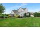 Expansive backyard with lush greenery, fencing and covered patio at 2026 Thatcher Way, Fort Mill, SC 29715