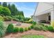 Landscaped backyard features a stone fire pit surrounded by manicured greenery, perfect for entertaining at 2026 Thatcher Way, Fort Mill, SC 29715