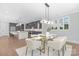 Modern dining area with glass-top table, seating for six, and kitchen in background at 2026 Thatcher Way, Fort Mill, SC 29715