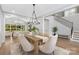 Open-concept dining area boasts a wooden table with seating for six, and chandelier at 2026 Thatcher Way, Fort Mill, SC 29715
